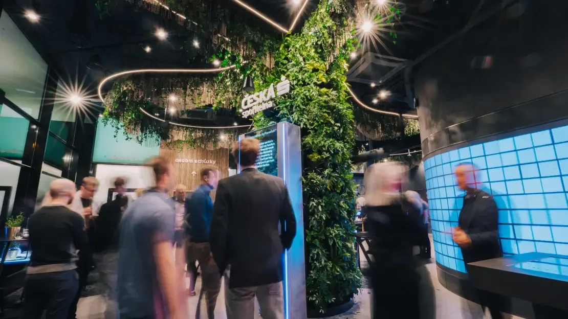 Visitors walking through the Future Lab — motion blur, kiosk in background